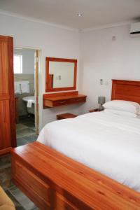 SeroweSerowe Hotel的一间卧室配有床、镜子和水槽