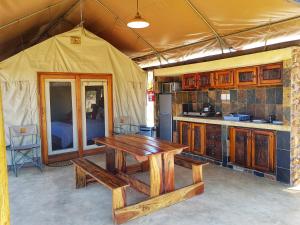 KlipdriftOuKlip Game Lodge的帐篷内的厨房配有木桌
