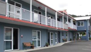 旺阿雷高地大道汽车旅馆的带阳台的蓝色建筑,前面设有长凳