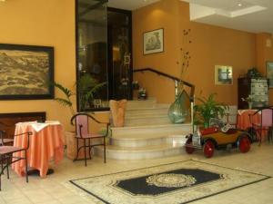 卡利特里安博夏朵利酒店的客厅设有楼梯,配有桌椅