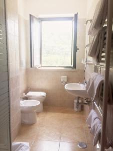 伊特里里奇奥酒店的一间带卫生间、水槽和窗户的浴室