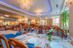 斯维诺乌伊希切北极星酒店的用餐室配有桌椅和吊灯。