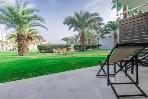 圣玛丽亚萨尔杜纳斯酒店的公园内带椅子和棕榈树的庭院