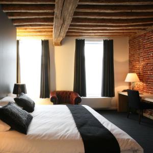 哈瑟尔特德格尼亨克斯酒店的酒店客房设有一张大床和窗户。
