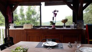 ArtiguelouveB&B En plein coeur de la forêt的一间带桌子和窗户的用餐室