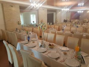 代日Hotel Elyon Dej的宴会厅配有桌椅和桌子。