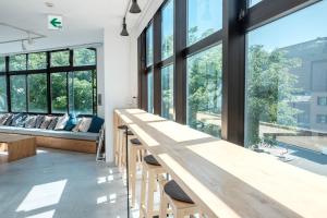 金泽金泽蓝色时光旅舍 的客房设有大窗户和一张长木桌