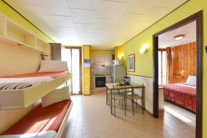安泰伊-萨伊恩特-安德尔埃贝尔维尤住宅酒店的带两张床和一张桌子的房间以及一间厨房