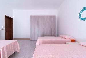 TrepuzziLa Terra的一间设有两张粉红色床单的床的房间