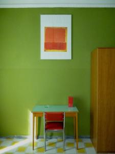 罗马Hotel Giamaica for Girls & Ladies Only的绿色的墙壁,配有桌子和两把椅子