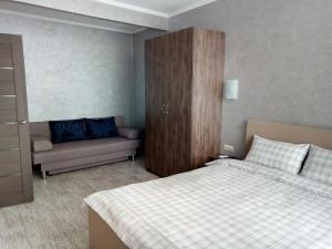 基辅Apartment complex Parklend的一间带床和沙发的小卧室