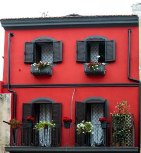 伊格莱西亚斯Sa domu rubia的红色的建筑,有黑色的窗户和花盆