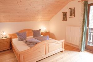 ScheibbsUrlaub mitten im Wald - Lueg的一间卧室配有一张带蓝色枕头的木床。