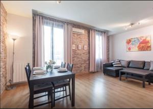 巴塞罗那中心公寓的客厅配有桌子和沙发