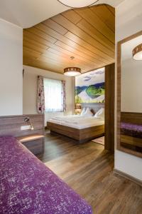 Obermühl吉尔林格酒店的卧室配有一张床,墙上挂有绘画作品