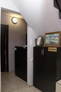 巴统Hotel Peria的一间房间,设有两个黑色橱柜和墙上的绘画