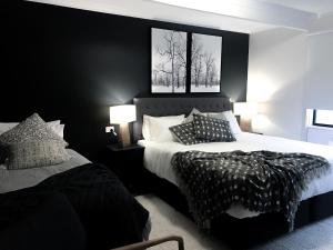 布勒山维多利亚滑雪俱乐部 - 艾弗惠塔克山林小屋的一间卧室设有两张黑墙床