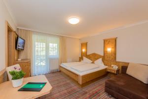 萨尔巴赫奥博尔达纳尔乡村酒店的酒店客房,配有床和沙发