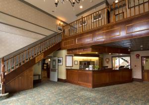道森市道森城韦斯特马克酒店的大型大堂铺有木地板,设有木制楼梯。