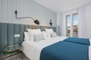 马拉加iloftmalaga Premium Alameda Principal的卧室配有蓝色和白色的床和窗户。