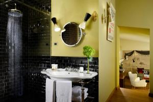 罗马Hotel De' Ricci - Small Luxury Hotels of the World的一间带水槽和镜子的浴室