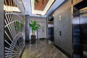 新加坡Hotel 81 Orchid的走廊上设有电梯和植物