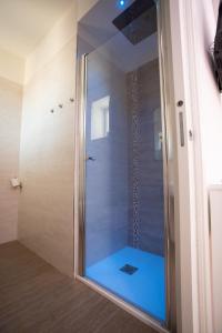索托马里纳拉格诺德奥罗酒店的浴室里设有玻璃门淋浴
