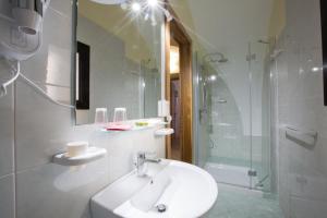 乌真托Le Dimore dei Messapi的白色的浴室设有水槽和淋浴。
