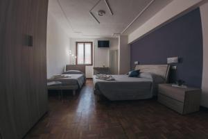 维罗纳Residenza al Castello的酒店客房设有两张床和一张桌子。