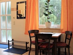 TarnewitzSpacious Apartment in Boltenhagen with Garden的餐桌、两把椅子和窗户