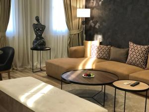 地拉那Hotel Deluxe的客厅配有沙发和桌子