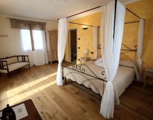 巴达卢科波齐奥迪马罗农家乐的一间卧室配有一张带天蓬的床