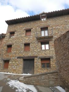 Linares de MoraHostal El Portalico的砖砌建筑,设有门和阳台