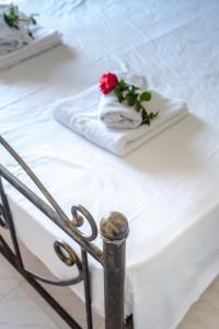 艾克索珀里斯Harma - Grand Sea & Mountains View的一张白色的床,上面有玫瑰花