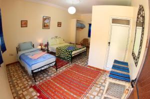 廷吉尔棕榈树宾馆的客厅配有两张床和地毯。
