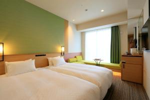 广岛八丁堀光辉酒店客房内的一张或多张床位