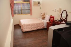 白河清秀旅社的一间小卧室,配有一张床和电视