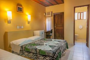 卡拉瓜塔图巴海岸旅馆的一间酒店客房 - 带一张床和一间浴室