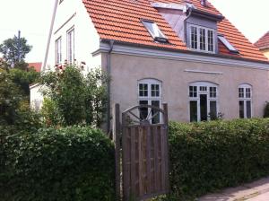 哥本哈根Villa Valby的通往橙色屋顶的房子的大门
