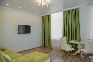 敖德萨Sea View Odessa的客厅配有绿色沙发和桌子