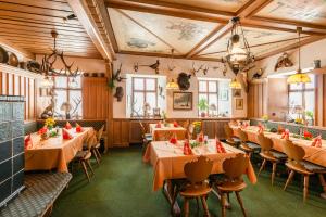 伊普霍芬Gasthof & Hotel Goldene Krone的一间在房间内配有桌椅的餐厅