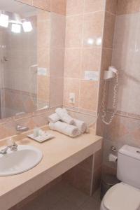 费德拉西翁Costa Del Sol的一间带水槽、卫生间和镜子的浴室