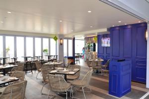 新山Suasana Residence JB City Lifestyle Suites by NEO的餐厅拥有紫色的墙壁和桌椅