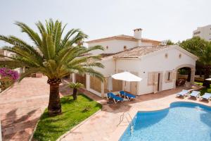 萨科马Villa Sa Coma的一座别墅,设有游泳池和棕榈树