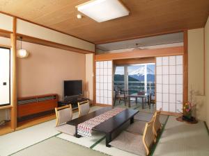 富士河口湖新世纪酒店的客厅配有桌子,享有山景