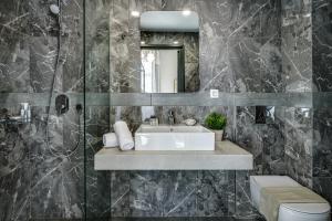 干尼亚Mosaic的一间带水槽和镜子的浴室