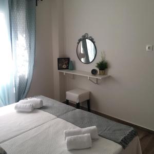 雅典lovely place to be的一间卧室配有一张带镜子的床和窗户