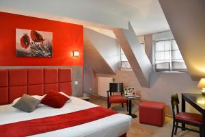 克莱西赛特诺曼德之家酒店的一间卧室配有一张大床和红色床头板