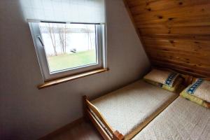 AntaiksnėKaukiškė的小房间设有两张床和窗户