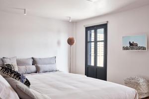 DrafakiPeriscope Suite Private Jacuzzi的白色的卧室设有床和窗户